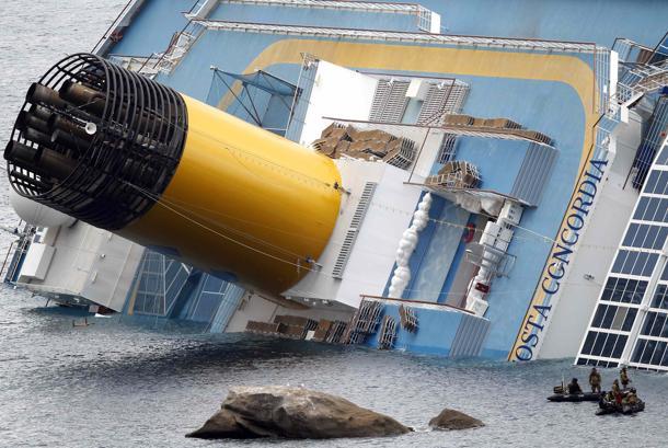 9.jpg - Rescuers on power rafts are seen next to the Costa Concordia cruise ship that ran aground off the west coast of Italy, at Giglio island January 15, 2012.Teams were painstakingly checking thousands of rooms on the cruise ship for nearly 40 people still missing, more than a day after the huge vessel foundered and keeled over with more than 4,000 on board, killing at least three people and injuring 70.  REUTERS/ Max Rossi    (ITALY - Tags: DISASTER TRANSPORT MARITIME TPX IMAGES OF THE DAY)